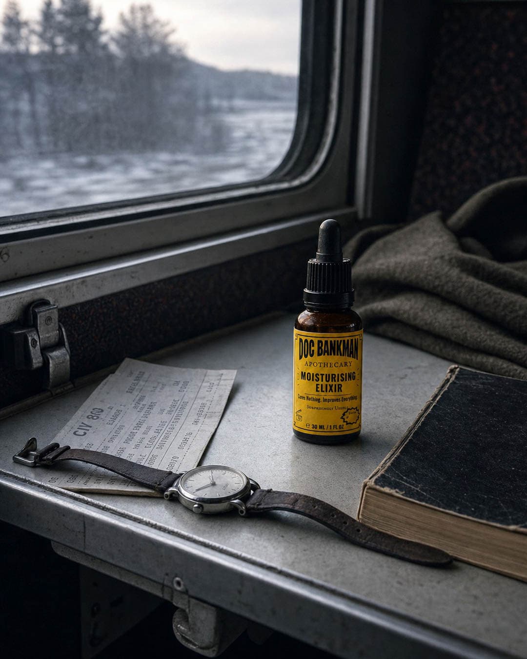 The bottle on a night-train fold-down tray at first light